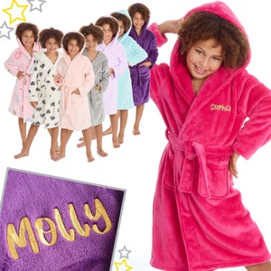 May include: A group of children wearing colourful hooded robes with personalised embroidery. The robes are soft and plush, perfect for lounging around the house. The names "Molly" and "Sophia" are embroidered on the robes.
