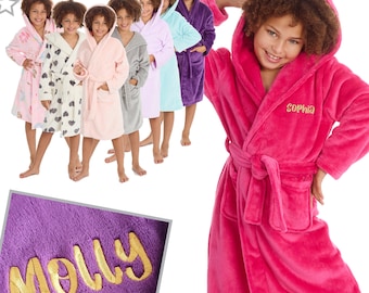 May include: A group of children wearing colorful hooded robes with personalized embroidery. The robes are soft and plush, perfect for lounging around the house. The names "Molly" and "Sophia" are embroidered on the robes.