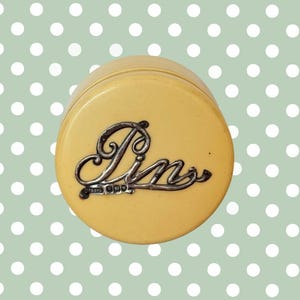 May include: A set of three ceramic mugs with a speckled, cream-colored glaze. Each mug features a different hand-painted floral design in shades of blue, green, and yellow. The mugs have a simple, rounded shape and a comfortable handle.