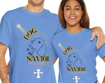 May include: Two light blue t-shirts with a graphic design of a dog with a halo and the text "DOG is my SAVIOR" and a cross bone.