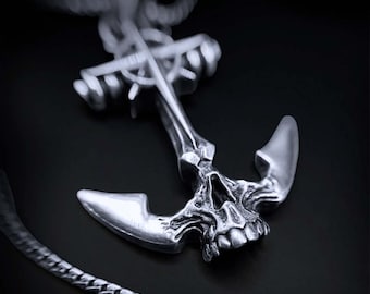 May include: A silver anchor pendant necklace with a skull design. The anchor is detailed with a cross and rope design.