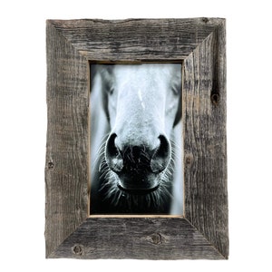 May include: A rustic wooden picture frame with a black and white photo of a horse's nose inside. The frame is made of reclaimed wood and has a natural, weathered finish.
