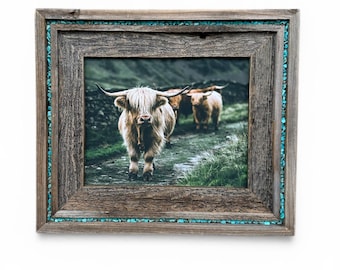 May include: A framed print featuring three Highland cows on a path. The rustic wooden frame is accented with turquoise-colored stones. The print showcases the cows in a natural outdoor setting, with a focus on their shaggy coats and horns.