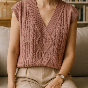 “Close-up of braided cable stitches on a handmade green knitted vest.”