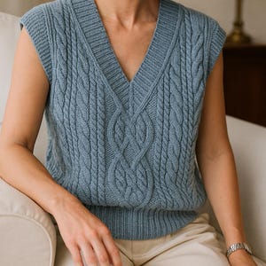 “Front view of cable-knit V-neck vest paired with beige trousers, showing detailed stitch work.”
