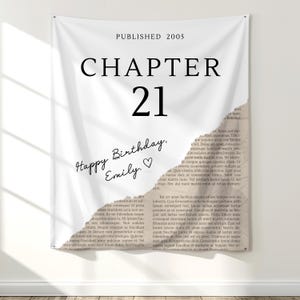May include: A white banner with the text "CHAPTER 21" in large black letters. Below, it reads "Happy Birthday, Emily." and "PUBLISHED 2005". A torn paper design is on the right side.