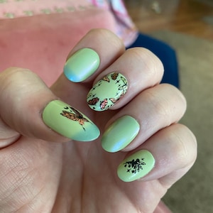 Fairy manicure, green thermal with orange and yellow butterfly wings, fantasy nails