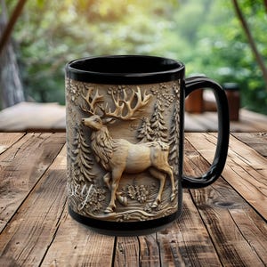 May include: Black ceramic mug with a 3D carved design of a deer in a forest setting. The deer is brown and has large antlers. The mug has a black handle.
