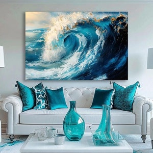 May include: A white sofa with blue cushions in a living room setting. A large painting of a blue ocean wave hangs above the sofa. The room has a white rug with a blue design and a glass coffee table with blue vases.