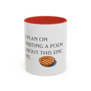 May include: White ceramic mug with a red rim. The mug has black text that reads "I plan on writing a poem about this epic pie." and a cartoon image of a pie.