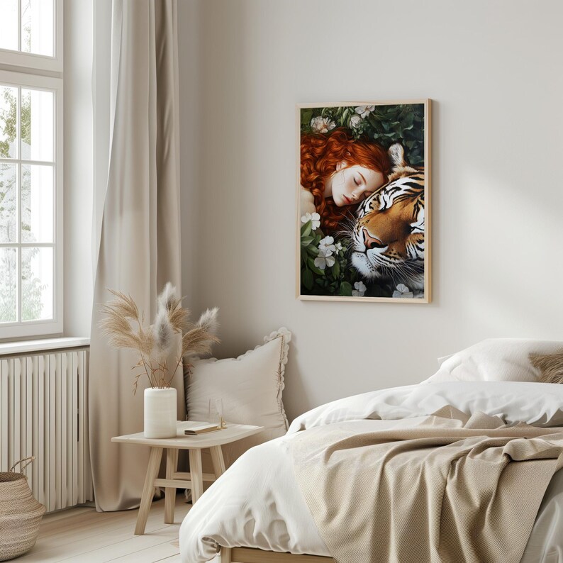 May include: A framed print of a woman with long red hair sleeping with a tiger. The woman is wearing a white dress and the tiger is lying on top of her. The background is a lush green forest with white flowers.