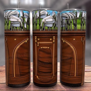 May include: Three brown leather golf bag-style tumblers with a design of golf clubs on the top half. The tumblers are insulated and have a stainless steel exterior.