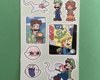 May include: A sheet of stickers featuring characters from the Super Mario franchise. The stickers include Mario, Luigi, Peach, and various ghosts. The stickers are printed on white paper with a green background.
