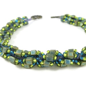 May include: A multi-strand beaded necklace with green, blue, and purple beads. The necklace is made with a variety of bead shapes and sizes, creating a unique and textured look.