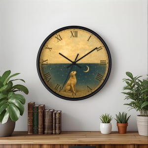 May include: A round wall clock with a black frame. The clock face features a dog looking up at a crescent moon and stars, with a yellow and blue background. Roman numerals mark the hours. The clock hands are black.