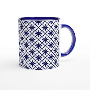 May include: White ceramic mug with a blue floral pattern and a blue handle and interior. The floral design is a repeating pattern of stylized flowers in navy blue. The mug is set against a white background.