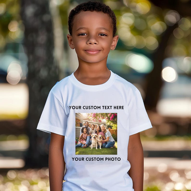 May include: A white t-shirt featuring the text "YOUR CUSTOM TEXT HERE" above a family photo with two dogs. The bottom of the shirt reads "YOUR CUSTOM PHOTO". The shirt is worn by a young boy.