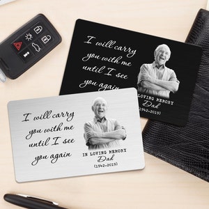 May include: Two silver metal memorial cards with a black and white photo of a man. The text on the cards reads "I will carry you with me until I see you again."  The cards also include the text "In Loving Memory Dad (1942-2019)".