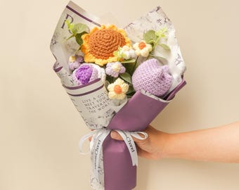 May include: A bouquet of crocheted flowers in a purple paper wrapping. The bouquet includes a yellow sunflower, purple tulips, and white flowers. The paper wrapping has the text "Live a good life, meet you when you're traversing the world".