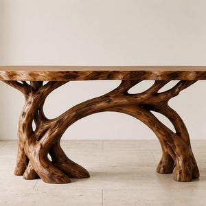May include: A console table crafted from natural brown wood, featuring a smooth, rectangular top surface supported by a base composed of interconnected, organic tree root structures that extend to the floor in a branching, sculptural formation.
