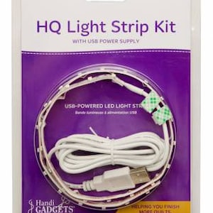 May include: A white USB-powered LED light strip kit with a white cord and a USB plug. The light strip is packaged in a clear plastic clamshell with a purple background and the text "HQ Light Strip Kit with USB Power Supply" and "Handi Gadgets".