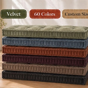 May include: A stack of seven rectangular velvet cushions in various colors, including olive green, navy blue, and dark brown. The cushions have a tufted design and are stacked on top of each other. Text on the image reads "Velvet", "60 Colors", and "Custom Size".