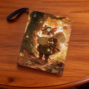 May include: A rectangular, illustrated pouch featuring a cartoon squirrel wearing goggles and reading a book in a forest setting. The pouch has a black strap and is set against a wooden surface.