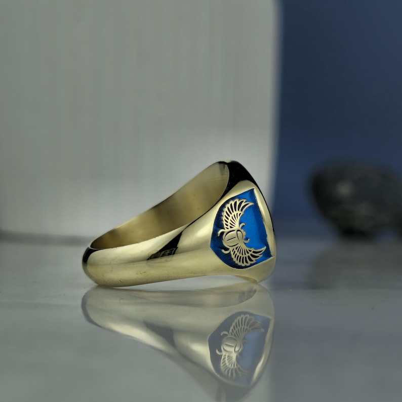 A symbol of wisdom and spiritual passage, this Anubis-themed ring brings together ancient Egyptian belief and artisan jewelry. Handcrafted in Turkey with high-quality 925 sterling silver and gold plating, it features intricate enamel work and symbolism rooted in the afterlife rituals of Egypt. Whether worn for its cultural meaning or its bold visual impact, this ring offers durability, elegance, and a connection to ancient divinity.