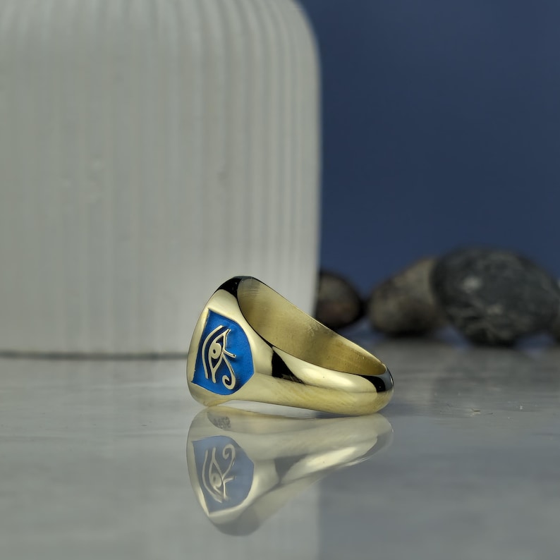 This square Anubis ring brings together divine symbolism and wearable art. The stunning hand-engraved details and vibrant enamel surface showcase the jackal god’s strength and sacred duty in ancient funerary rites. Forged in sterling silver with gold plating, this piece reflects sophistication and spiritual identity. A rare fusion of past and present, tradition and trend.