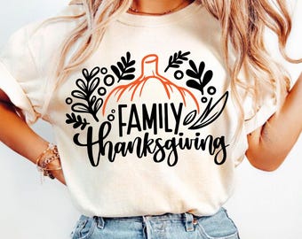 May include: White t-shirt with a black and orange pumpkin graphic and the text "FAMILY Thanksgiving".