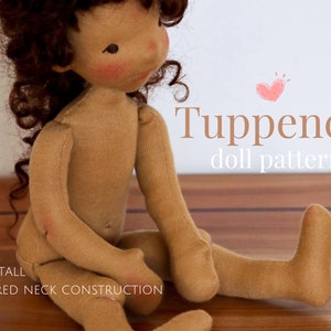 May include: A 12-inch tall doll pattern called "Tuppence doll pattern". The doll is made of brown fabric and has curly brown hair. The doll is sitting on a wooden surface.
