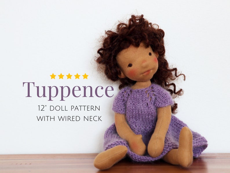 May include: A 12-inch doll pattern with a wired neck. The doll has brown curly hair, a purple knitted dress, and a tan complexion. The pattern is called "Tuppence".