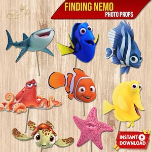 May include: A collection of colorful Finding Nemo photo props, including a shark, a blue tang, a clownfish, and a starfish. The props are on sticks and feature vibrant colors and detailed designs. The text "FINDING NEMO PHOTO PROPS" is displayed at the top.