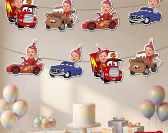 May include: A festive banner featuring cartoon car cutouts with children's faces, perfect for a birthday party. The cars are red, blue, and brown, with a cake and balloons in the foreground. The banner is strung across a wall.