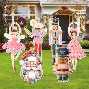 May include: A collection of colorful Christmas yard decorations featuring characters from The Nutcracker ballet and Santa Claus. The figures include a ballerina, a mouse king, a nutcracker, a gingerbread soldier, and Santa Claus, all standing on a green lawn.