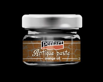 May include: A small glass jar of Pentart Antique Paste with a silver lid. The label features the words "Antique paste" and "orange oil" in a decorative font. The jar is filled with a dark brown substance.
