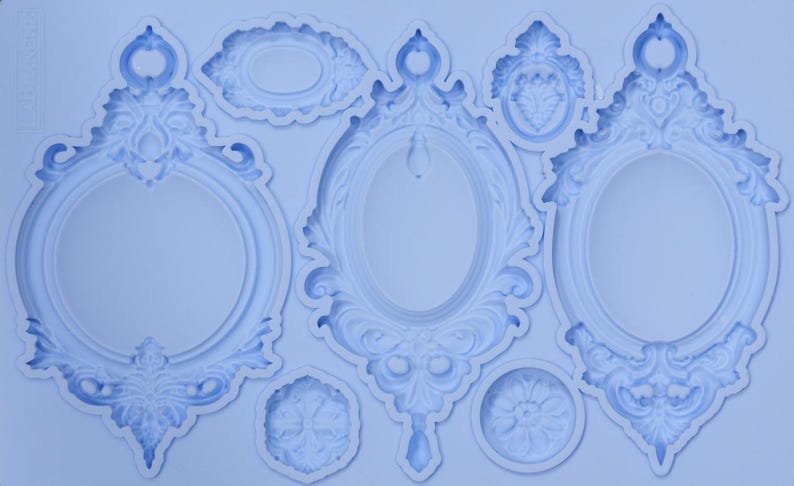 May include: A light blue silicone mold featuring various ornate frame designs. The mold includes oval and round frames with detailed scrollwork and decorative elements, suitable for crafting projects.