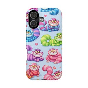 May include: A phone case featuring a repeating pattern of smiling cartoon Cheshire Cats in various colors, including pink, purple, blue, and green, on a light blue background with small pink hearts.