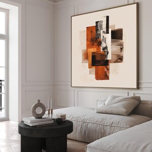 May include: Abstract art print with geometric shapes in orange, brown, black, and beige. A tree silhouette is included in the artwork. The framed canvas hangs above a modern sofa in a bright room. The room has white walls.