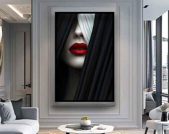 May include: A black and white portrait of a woman's face with red lipstick. The woman's hair is partially covering her face, creating a mysterious and alluring look.