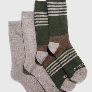 May include: Four pairs of socks in a variety of colors. Two pairs are solid light gray, while the other two pairs are green and brown with white stripes. The socks are made of a soft, textured material.