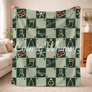 May include: A soft fleece blanket featuring a repeating grid pattern of alternating dark green and light sage squares. The squares display white line-art illustrations of Christmas icons including snowmen, stockings, gifts, trees, and sleds.