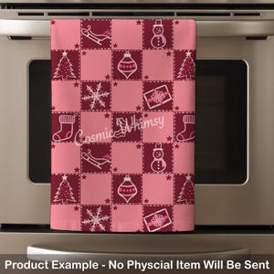May include: A rectangular kitchen towel featuring a checkered pattern of alternating light pink and dark maroon squares. The fabric displays white line-art icons of Christmas trees, snowmen, snowflakes, gift boxes, stockings, and sleighs.