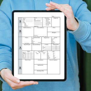 May include: A digital tablet displaying a medical assessment form. The form is divided into sections for patient information, medical history, and vital signs. The tablet is held by a person wearing a light blue hoodie.