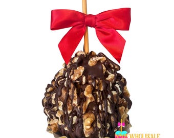 May include: A chocolate-covered apple with walnuts and a red bow on a stick. The apple is covered in chocolate and walnuts, and the bow is tied around the stick.