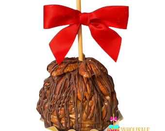 May include: A chocolate caramel apple topped with pecans and drizzled with chocolate. The apple is on a stick and has a red bow on top.