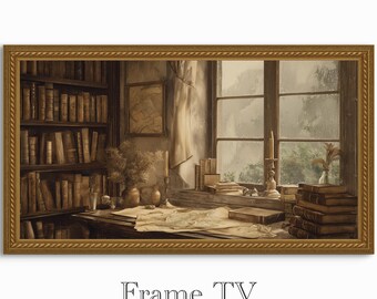 以下が含まれることがあります： ヴィンテージ図書館のシーンの額入りプリント。このアートワークは、大きな窓、本棚、本や地図のある机がある部屋を描いています。フレームは金色で、下部に「Frame TV」という文字があります。