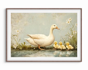 May include: A framed print of a white duck with three yellow ducklings near a body of water. The ducklings are huddled together. White flowers and green foliage are on the right and left sides of the image. The background is a light blue.