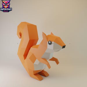 Op de afbeelding: Een geometrische papieren eekhoorn in tinten oranje, wit en grijs. De eekhoorn heeft een grote, volle staart en staat in een dynamische houding. Het Papercraft Dream-logo staat in de linkerbovenhoek.