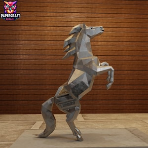 May include: A silver geometric horse sculpture rearing up on its hind legs. The sculpture is made of angular, metallic pieces, giving it a modern, abstract look. The sculpture is displayed on a concrete base against a wooden background.